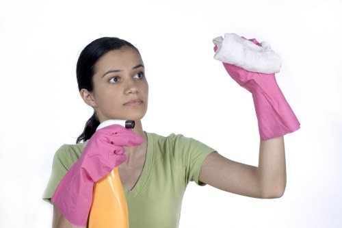 Local commercial cleaner working in a W1 office corridor with careful attention to detail