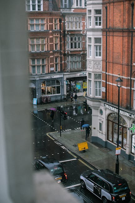 A view of a narrow residential street in Marylebone with red-brick buildings featuring white-framed sash windows. The area is well-lit with natural daylight, highlighting the clean brickwork and fresh